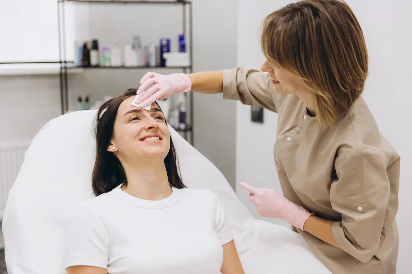 Woman getting her skin cleansed and cared for by a professional aesthetician